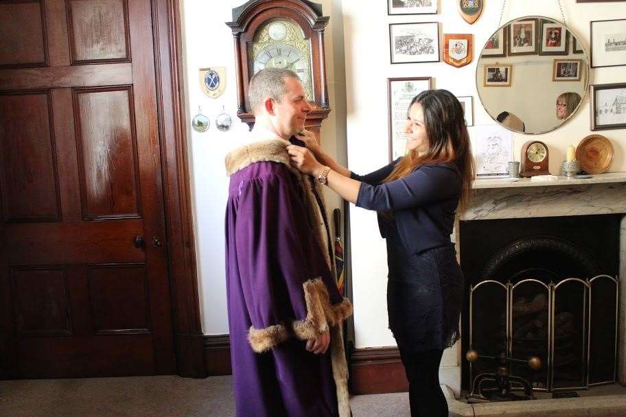 Andrew Lynn is helped into his official robes by wife Rima. (34868399)