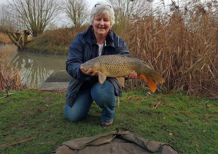 Bev Smith with a fine carp taken from Buttonhole Fishery
