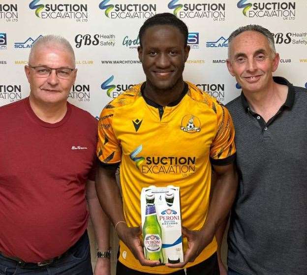 Flo Tsaguim receives his March Town man of the match award from Turner and son Funeral Directors