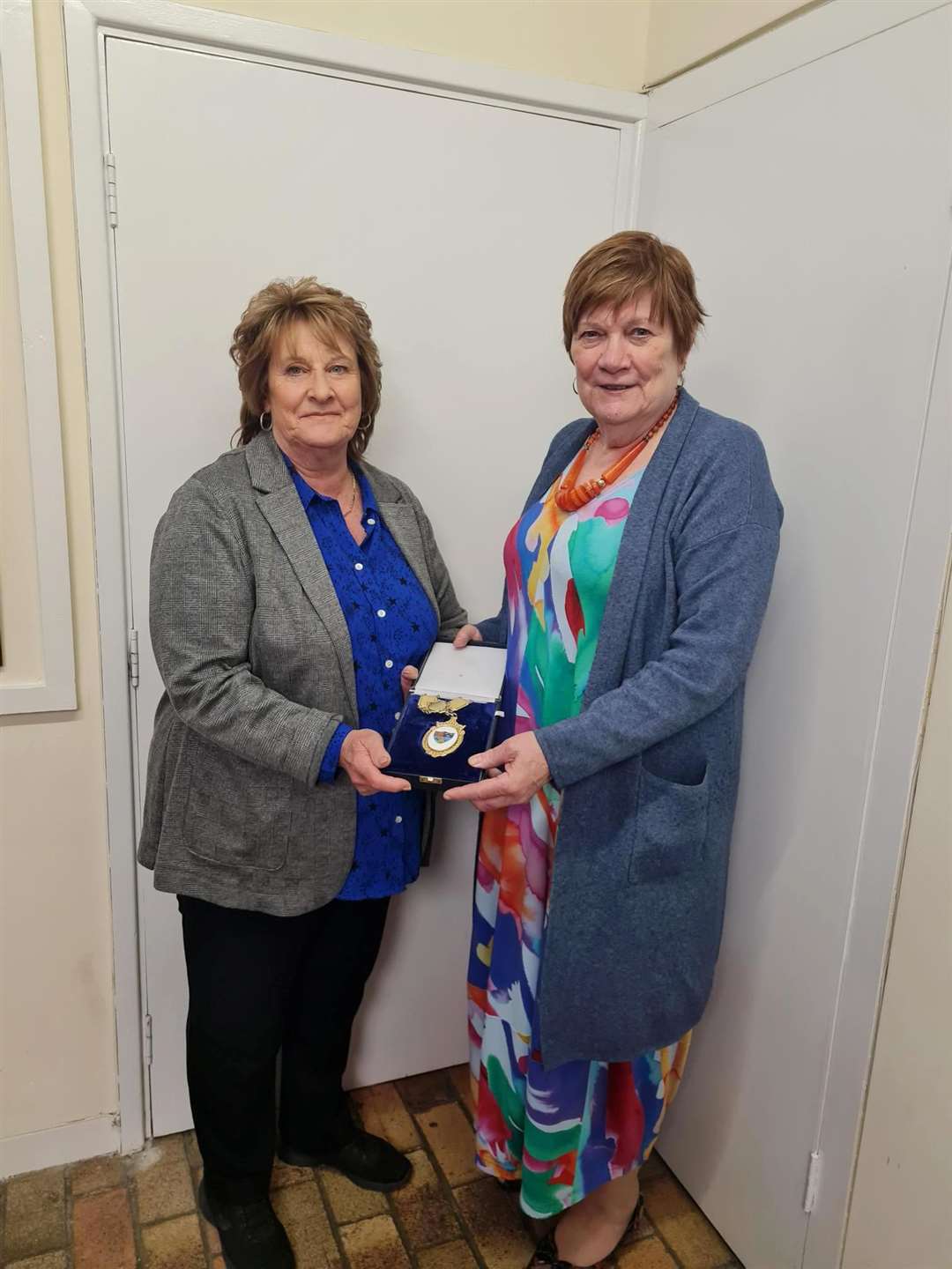 Councillor Linda Ashley (left) has handed over the mayoral chain of office to Councillor Anne Hay.