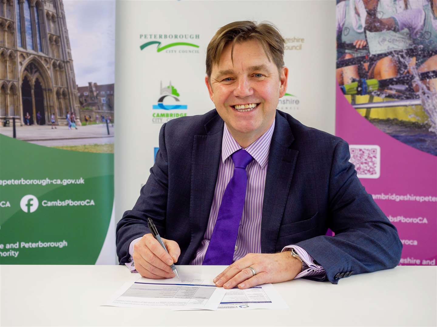 Mayor Dr Nik Johnson signing the decision notice confirming he has chosen franchising for Cambridgeshire and Peterborough's bus network. Picture: Combined Authority