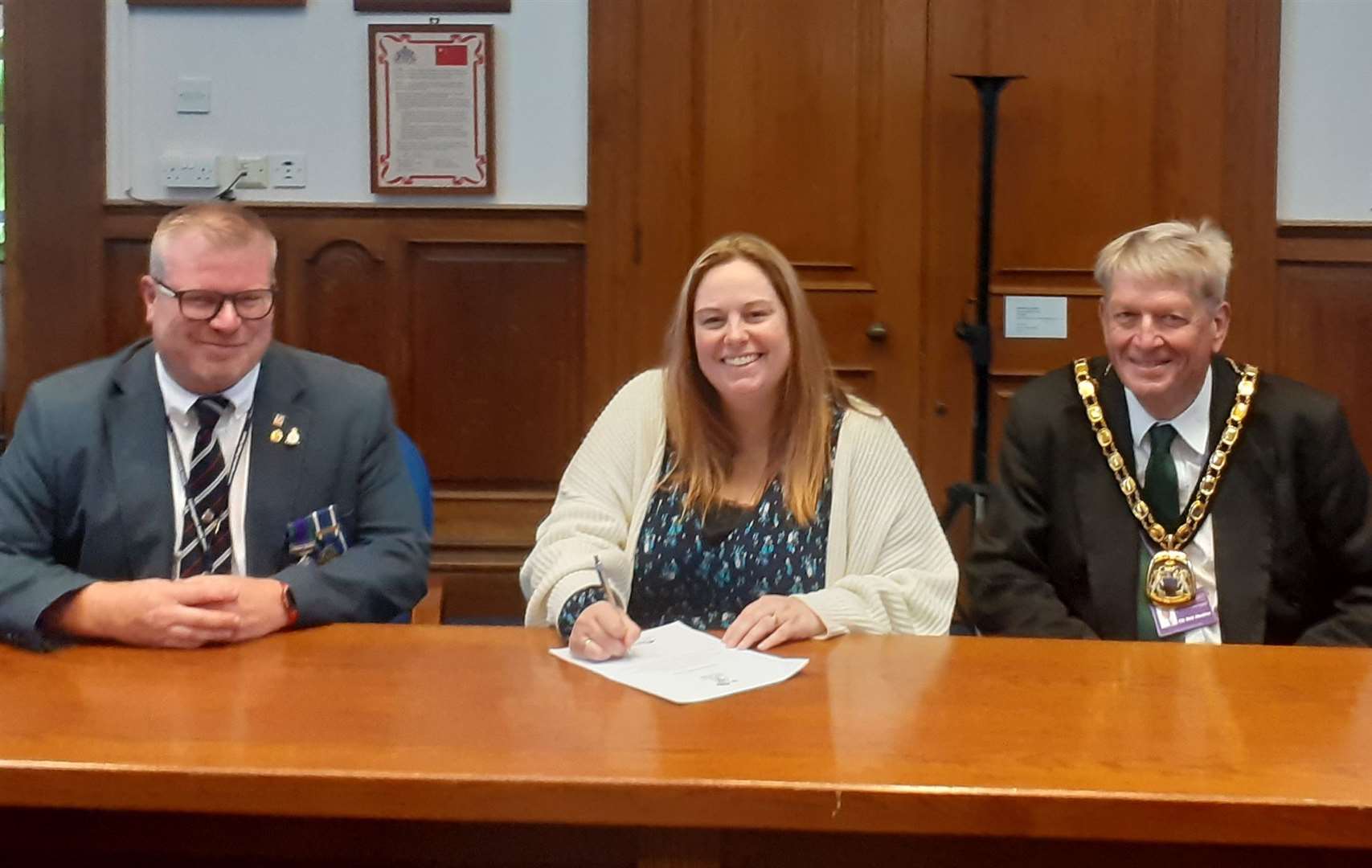 Cllr Susan Wallwork, centre, signs the covenant with, left, Tommy Kelly, Armed Forces Covenant Partnership Coordinator, Cambridgeshire and Peterborough, and district council chair Cllr Nick Meekins.