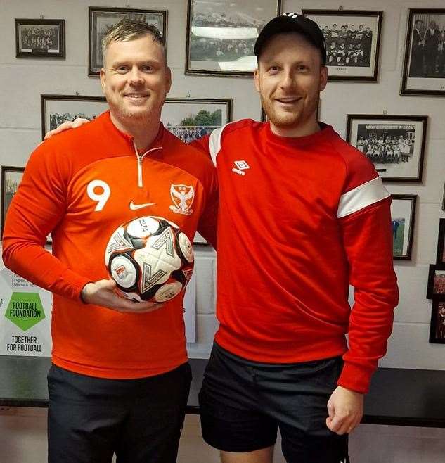 Parson Drove hat-trick hero Corey Kingston receives the match ball from assistant manager Callum Brown