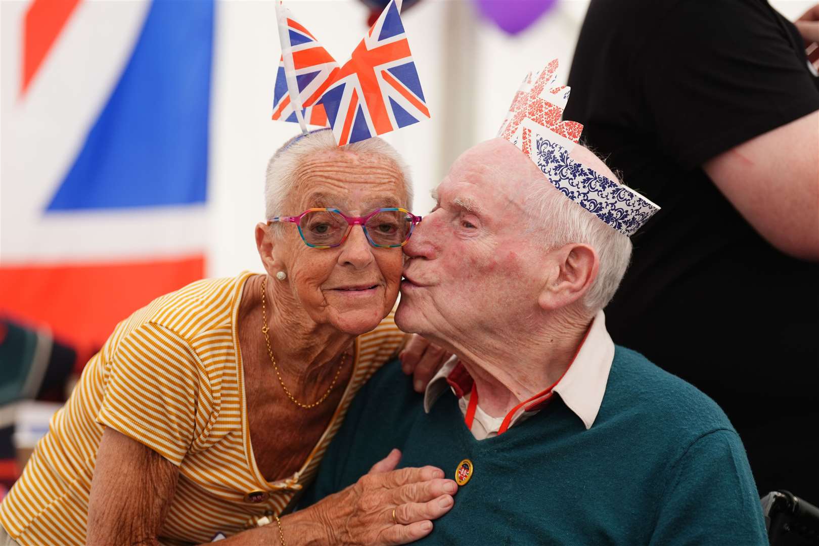 Veteran Andy Kirkland kisses a member of staff at a tea party at Erskine Veterans Home (Andrew Milligan/PA)